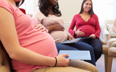 A group of expectant mothers are taking part in a group meeting.