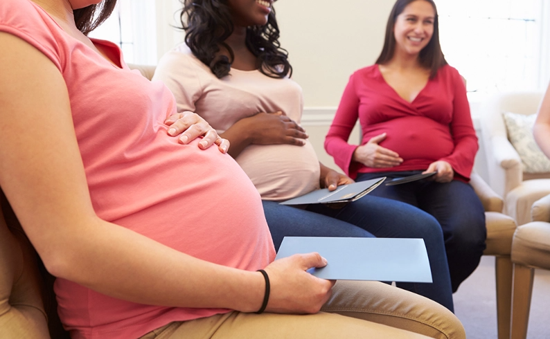 A group of expectant mothers take part in a group meeting.