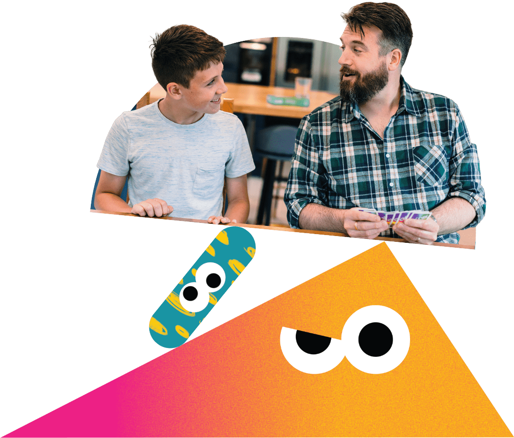 A father and son playing a card game together.