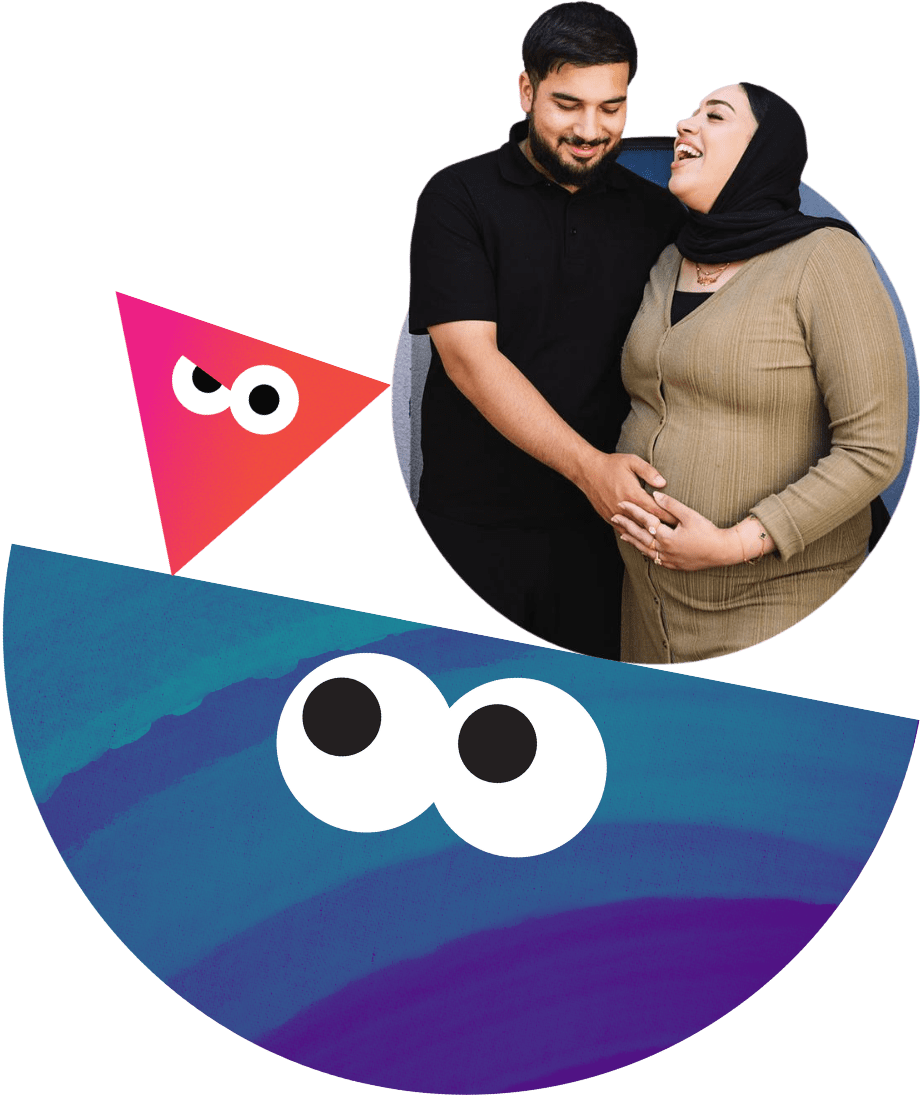 An expectant father holds the pregnancy bump of his pregnant partner.