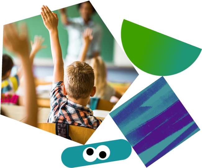 A boy raising his hand in a classroom.