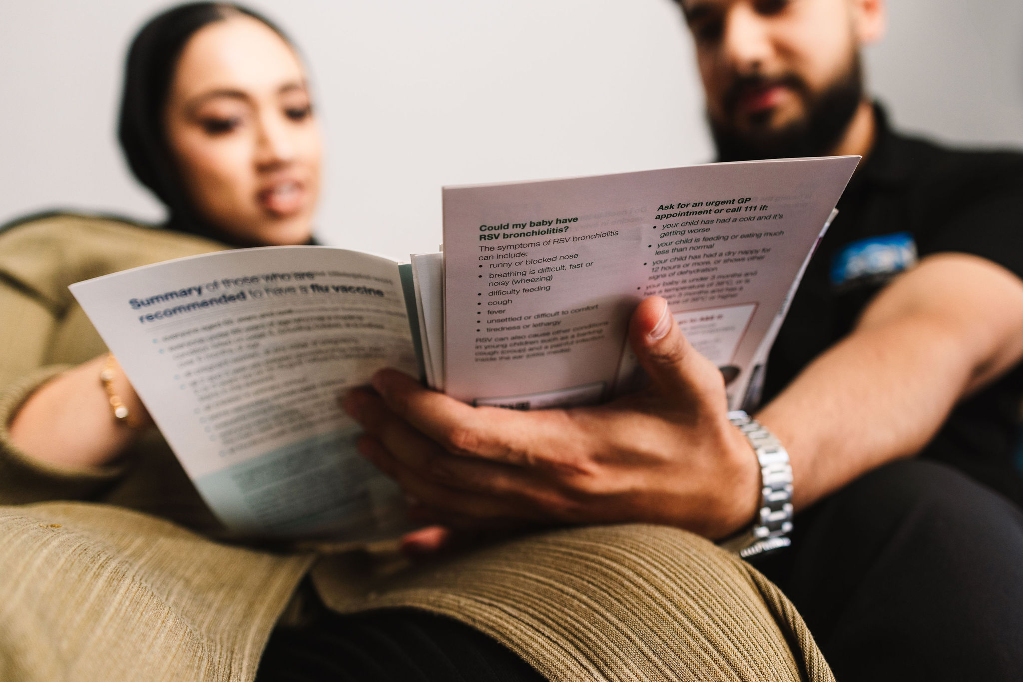 A couple read through a leaflet of information.