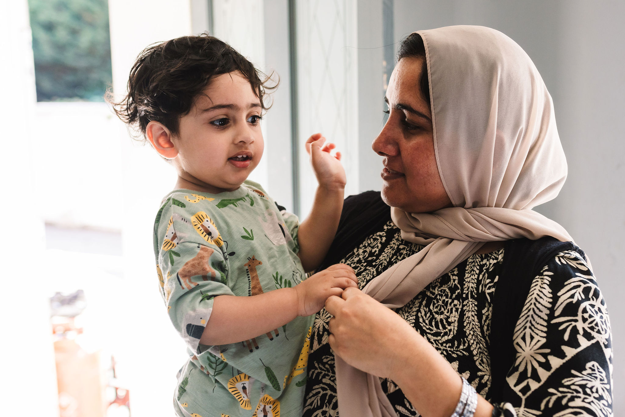A grandmother holding her grandchild.