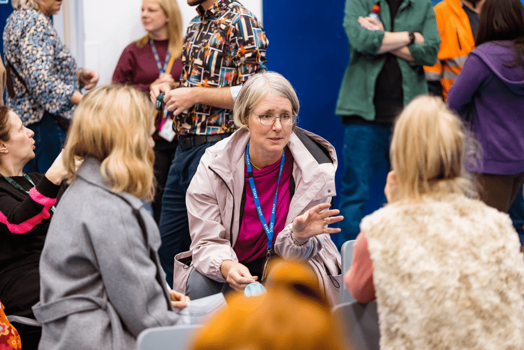 Teachers sat talking to one another.